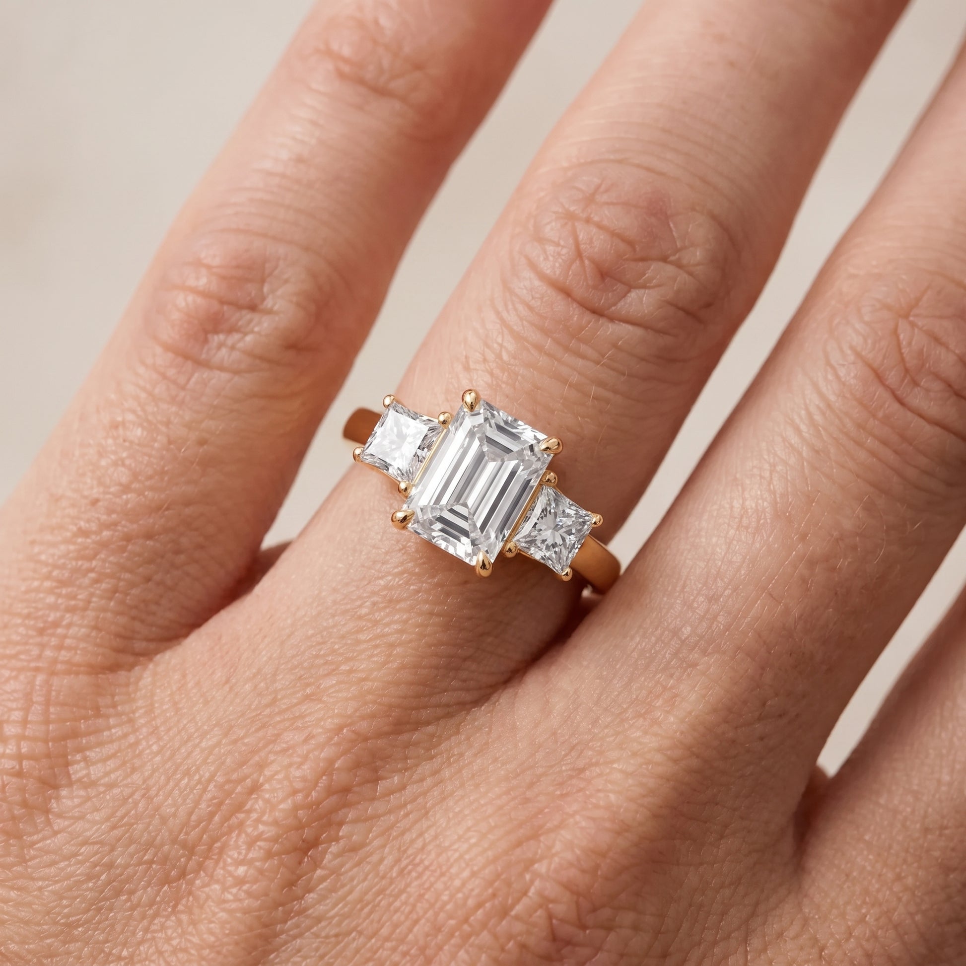 Sienna Three-Stone Emerald Diamond Ring in Yellow Gold - lifestyle.jpg