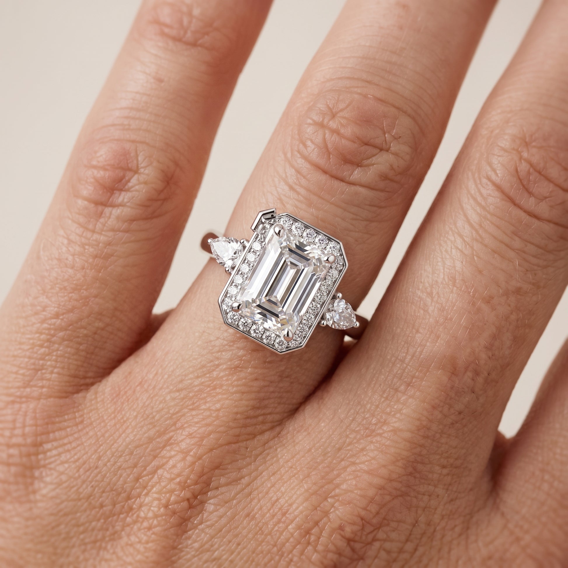 Eliza Halo Sidestone Emerald Diamond Engagement Ring in Platinum - lifestyle.jpg