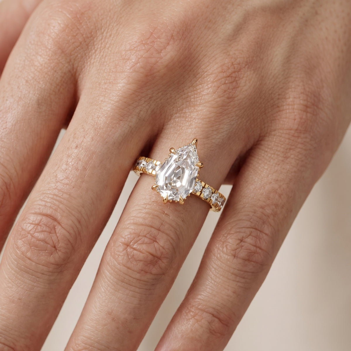 Delaney Hidden Halo French Pavé Step Cut Pear Diamond Engagement Ring in Yellow Gold - lifestyle.jpg