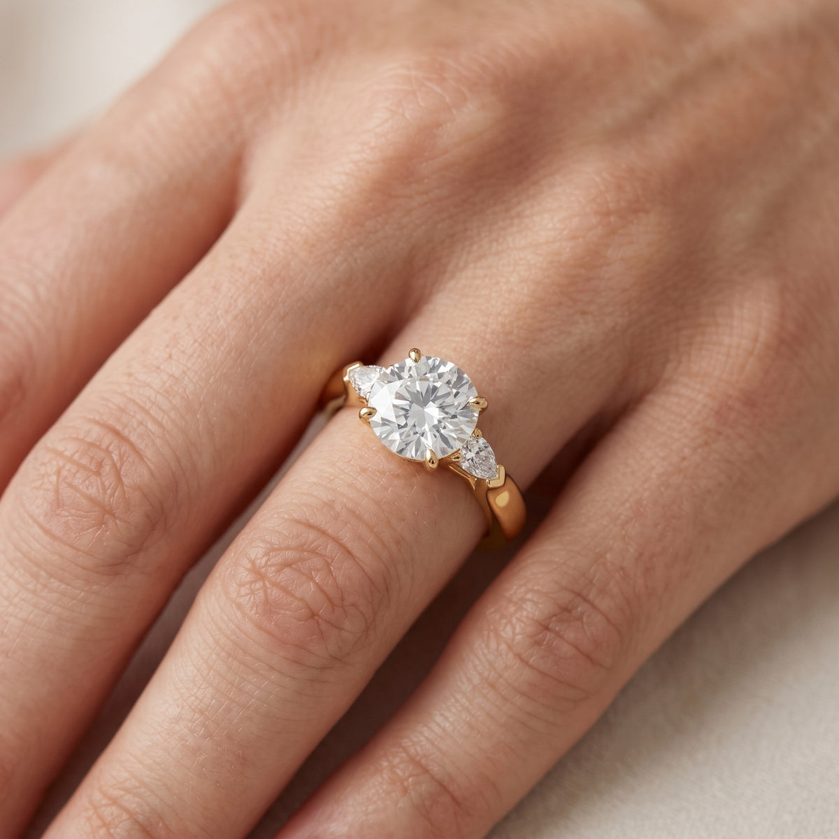 Dahlia Three-Stone Cathedral Round Diamond Engagement Ring in Rose Gold - lifestyle.jpg