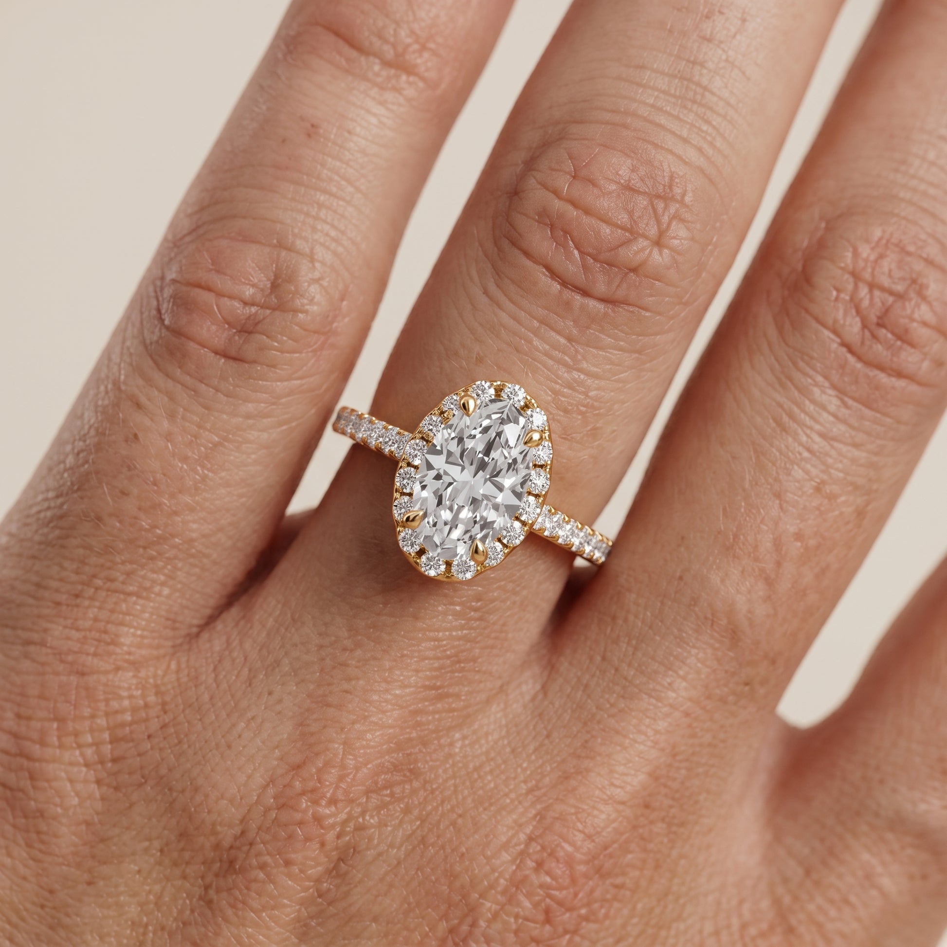 Amara Halo Claw Prong Oval Diamond Ring in Yellow Gold - lifestyle.jpg