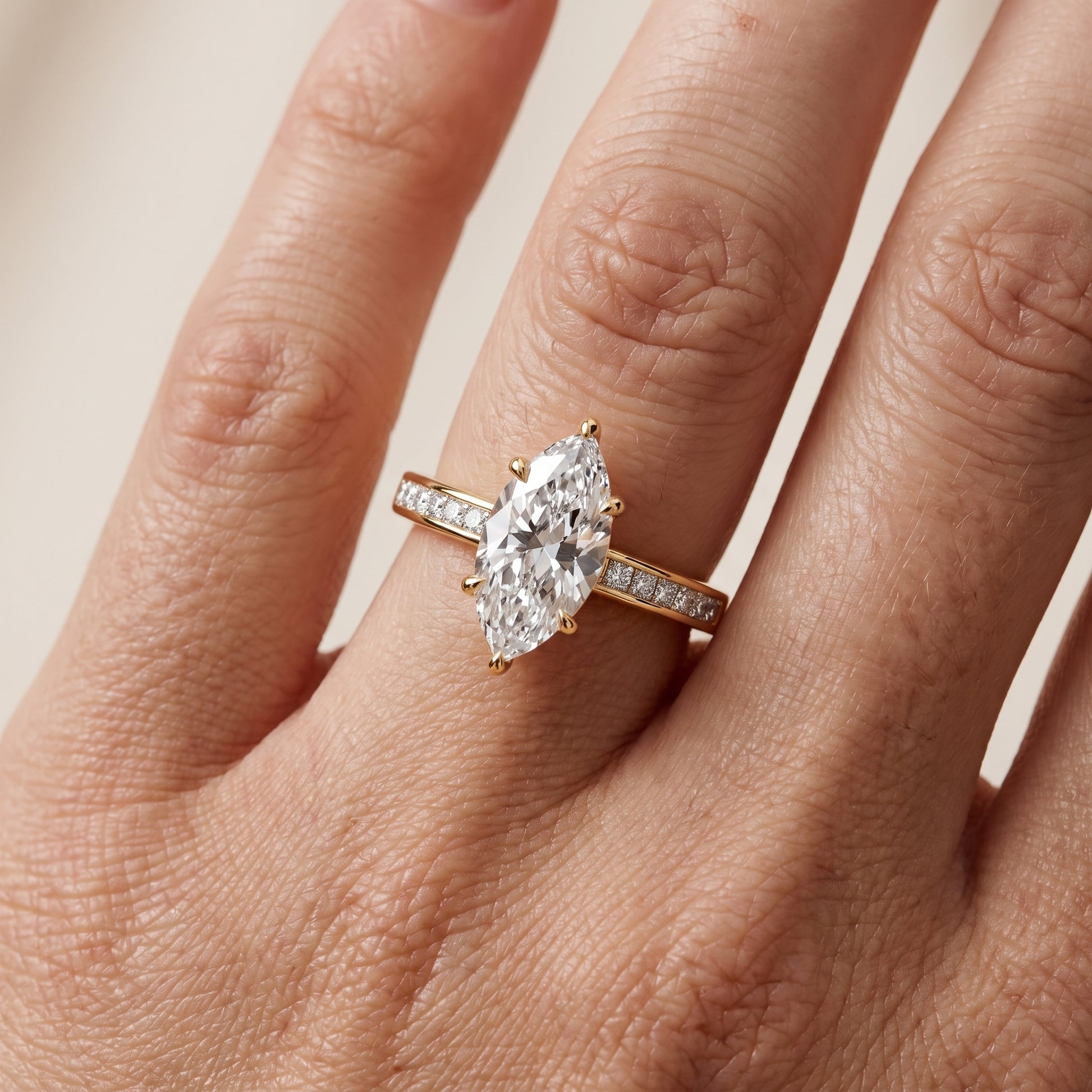 Maren Sidestone Channel Set Marquise Diamond Engagement Ring in Yellow Gold - lifestyle.jpg
