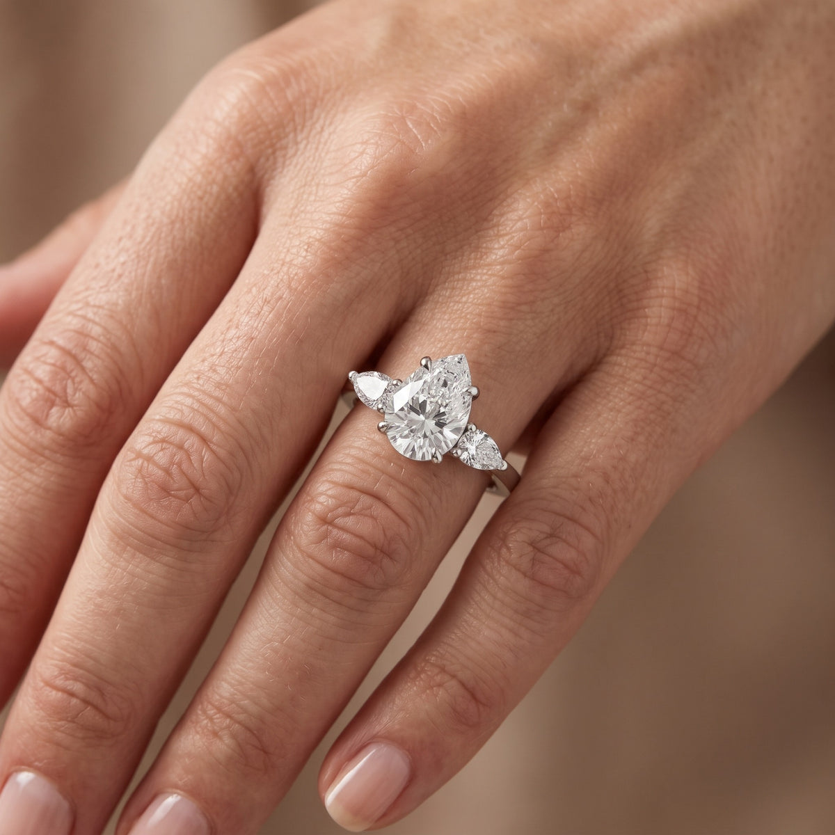 Grace Three Stone Pear Diamond Engagement Ring in Silver - lifestyle.jpg