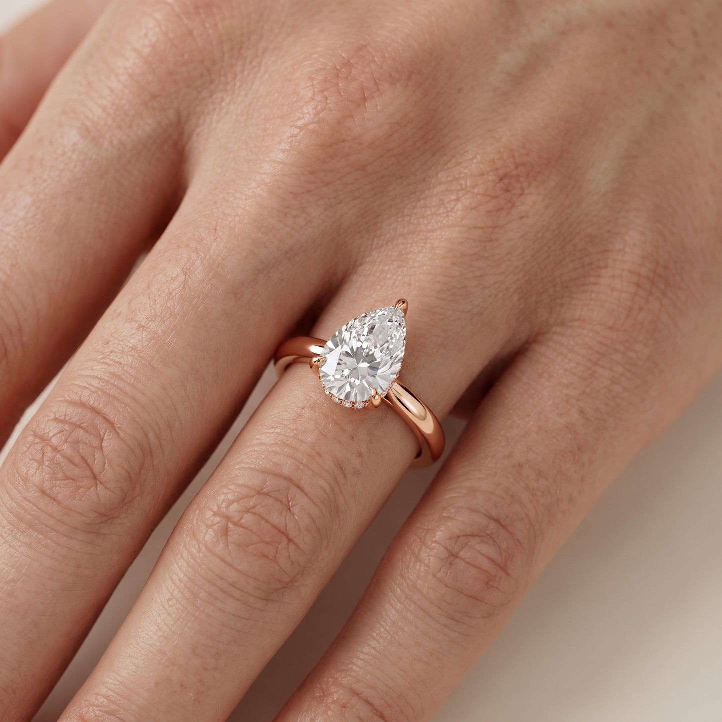 Mena Hidden Halo Pear Diamond Engagement Ring in Rose Gold - lifestyle.jpg