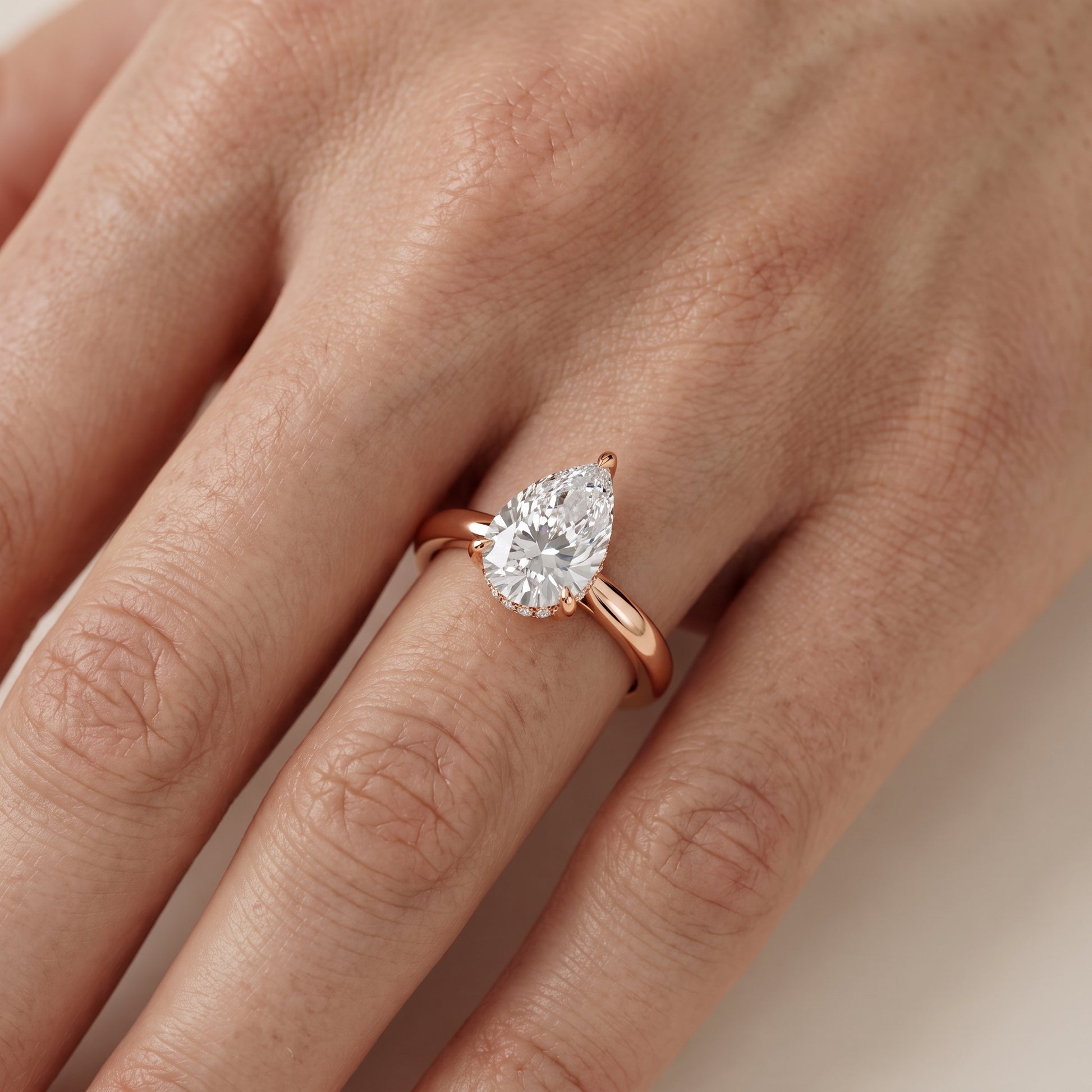 Mena Hidden Halo Pear Diamond Engagement Ring in Rose Gold - lifestyle.jpg