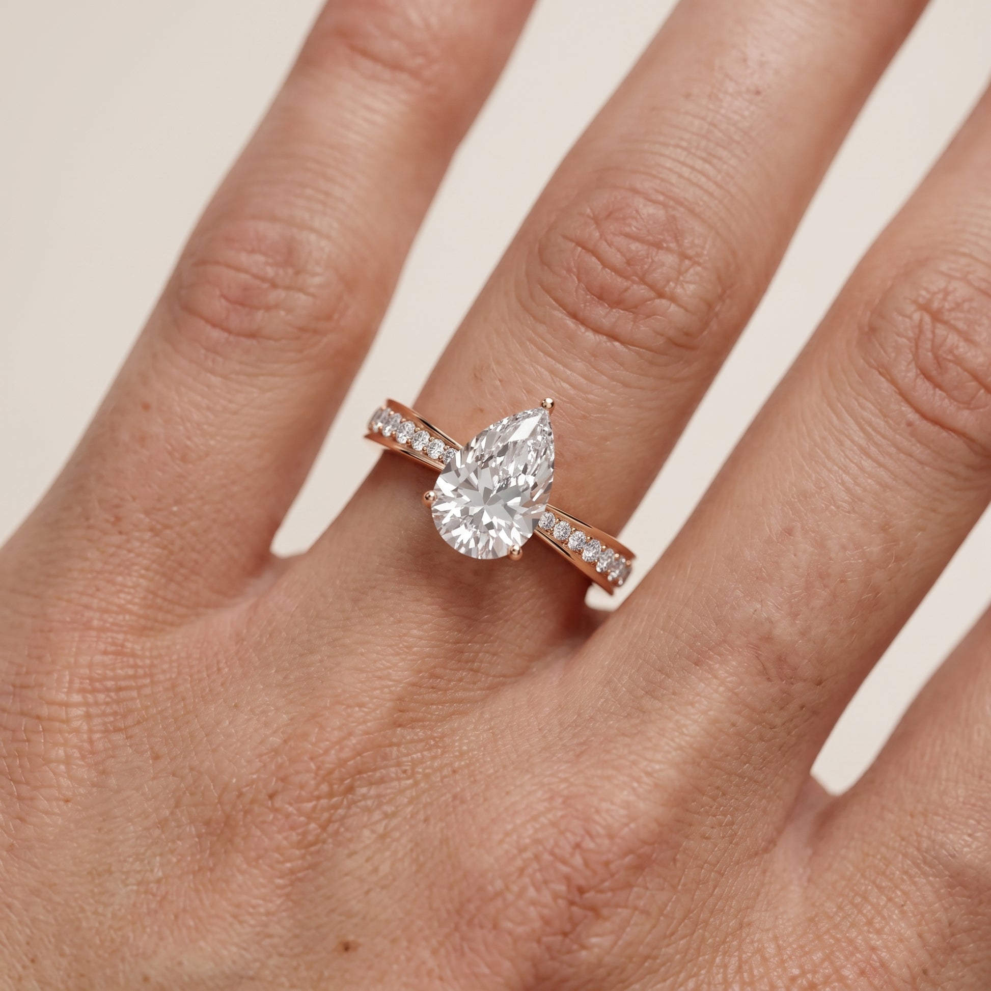 Rhea Sidestone Pavé Pear Diamond Engagement Ring in Rose Gold - lifestyle.jpg
