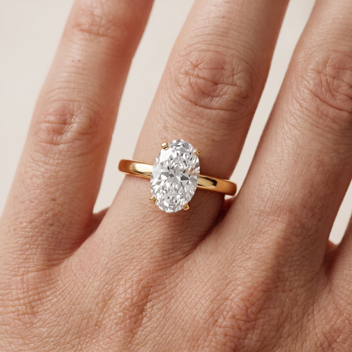 Liana Solitaire Claw Prong Oval Diamond Engagement Ring in Yellow Gold - lifestyle.jpg