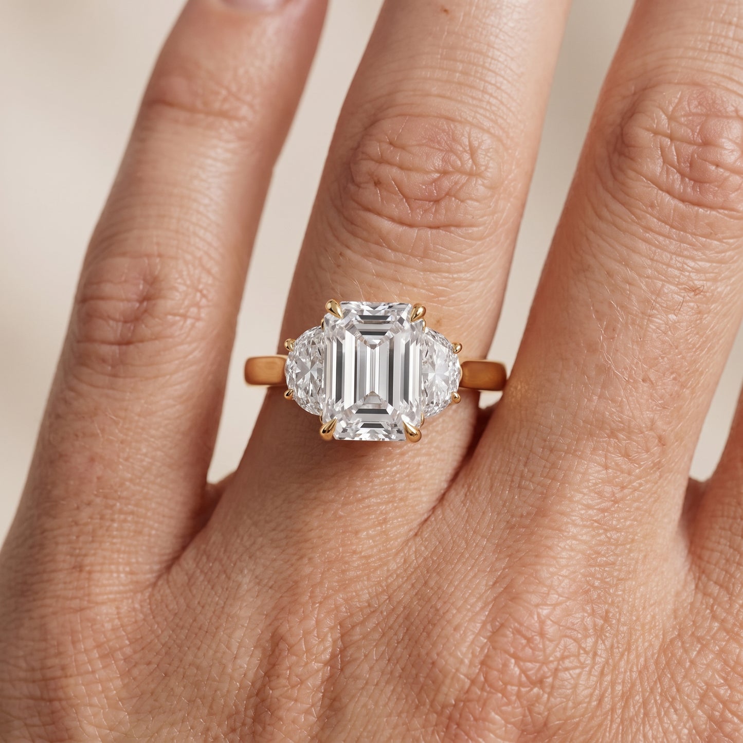 Romy Three-Stone Emerald Diamond Engagement Ring in Yellow Gold - lifestyle.jpg