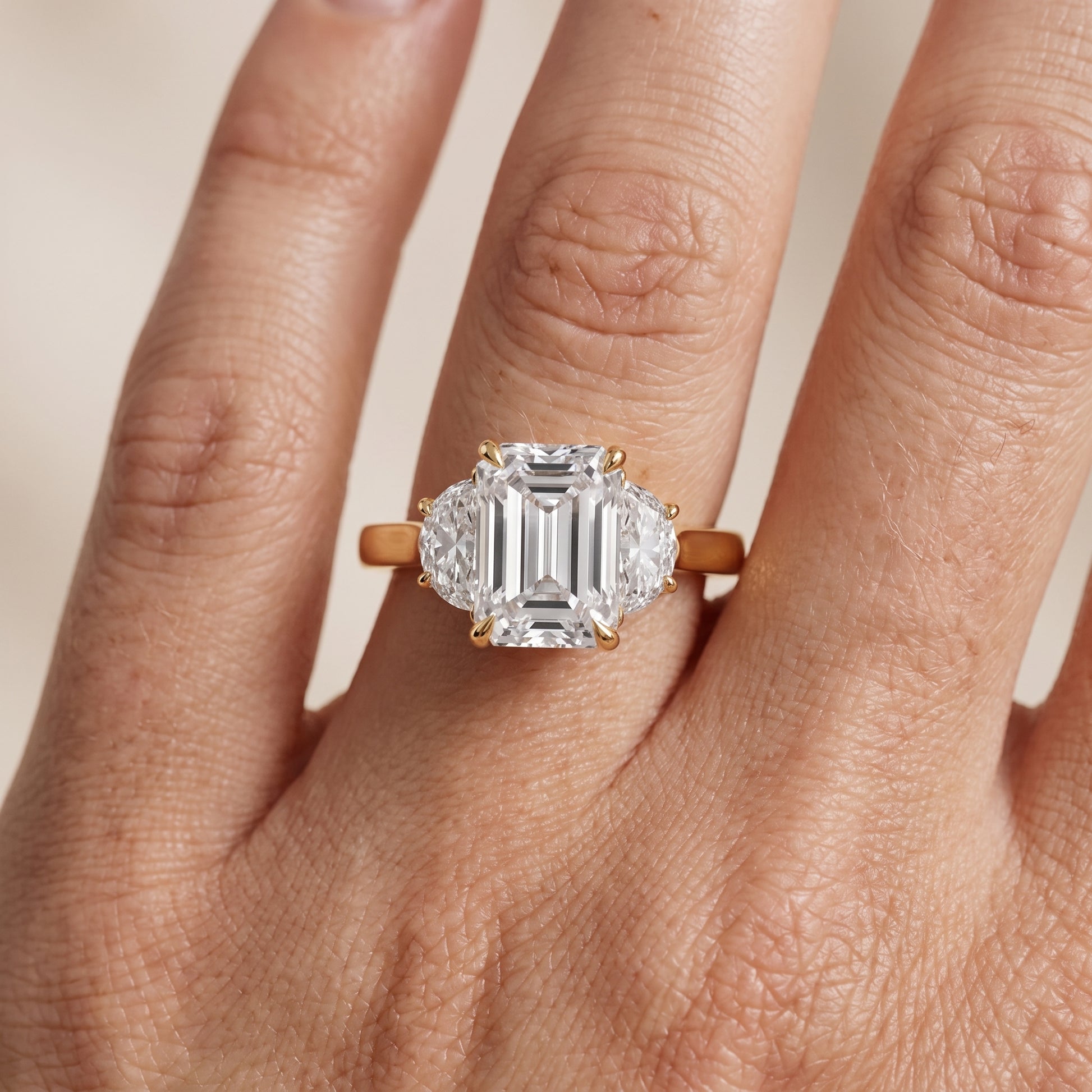 Romy Three-Stone Emerald Diamond Engagement Ring in Yellow Gold - lifestyle.jpg