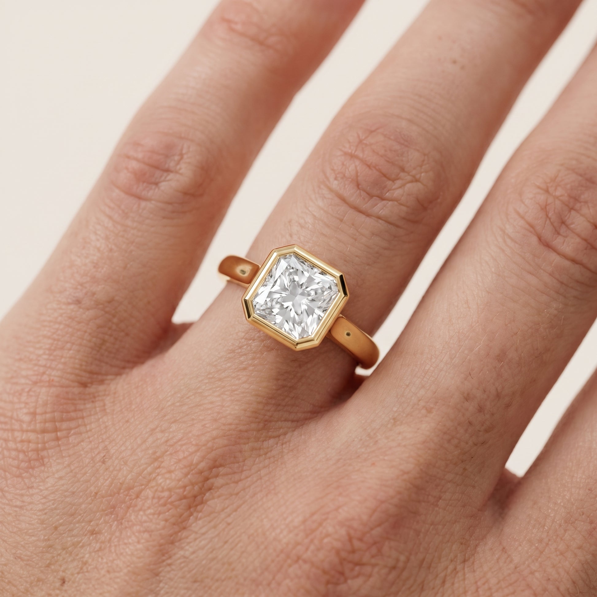 Jolie Bezel Solitaire Radiant Diamond Engagement Ring in Yellow Gold - lifestyle.jpg