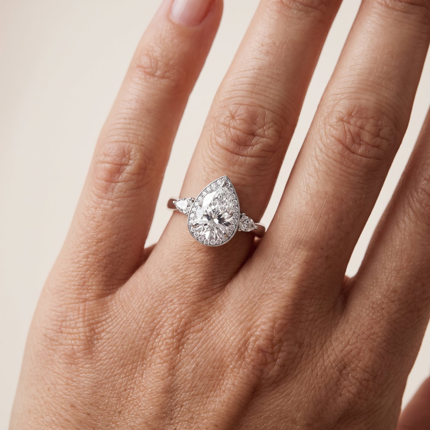 Eliza Halo Sidestone Pear Diamond Engagement Ring in Silver - lifestyle.jpg