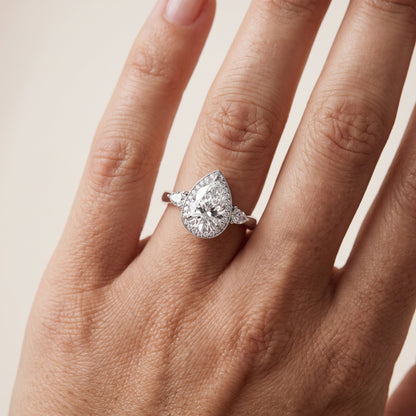 Eliza Halo Sidestone Pear Diamond Engagement Ring in Silver - lifestyle.jpg