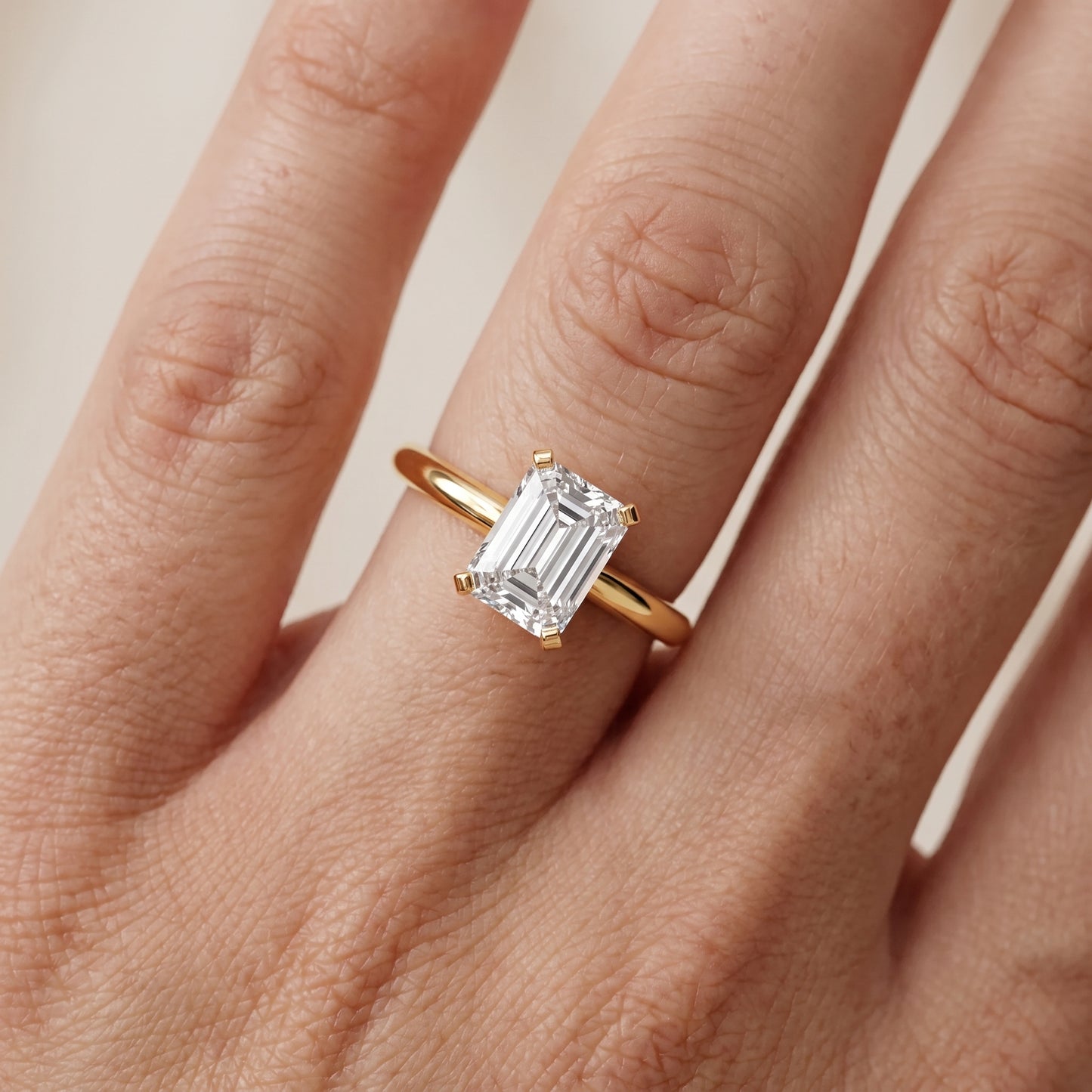 Amira Six-Prong Solitaire Emerald Diamond Engagement Ring in Yellow Gold - lifestyle.jpg