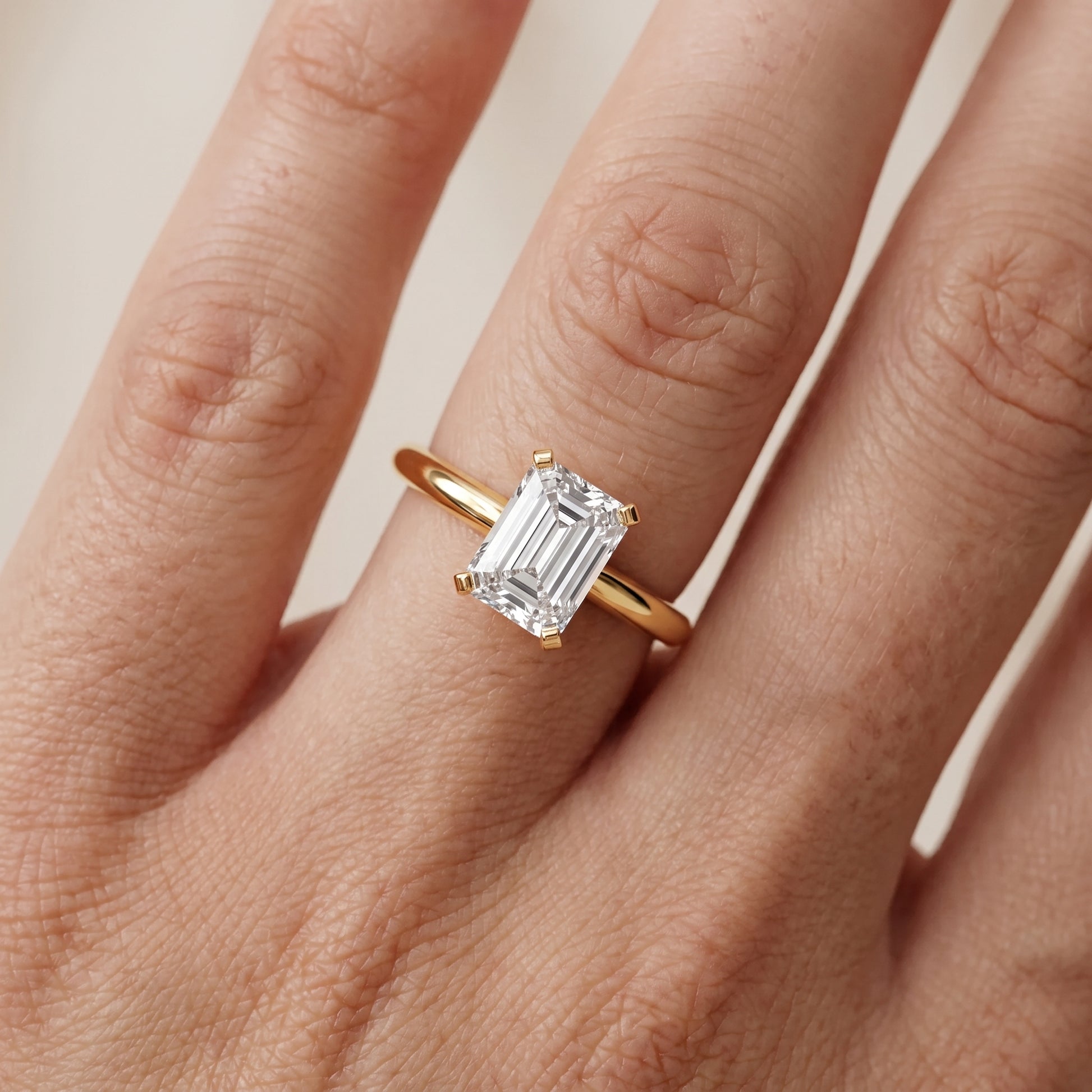 Amira Six-Prong Solitaire Emerald Diamond Engagement Ring in Yellow Gold - lifestyle.jpg