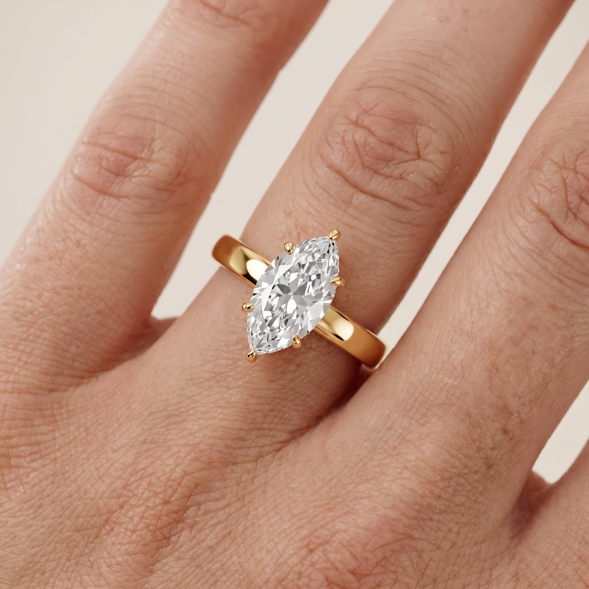 Lara Hidden Halo Marquise Diamond Engagement Ring in Yellow Gold - lifestyle.jpg