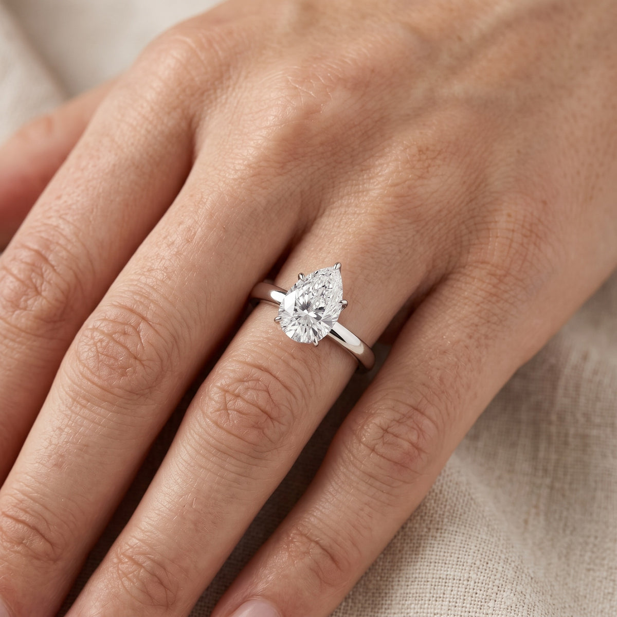 Serena Blossom Solitaire Pear Diamond Engagement Ring in Silver - lifestyle.jpg