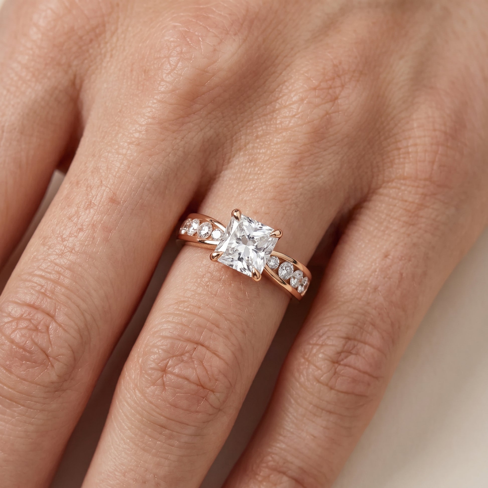 Noor Channel Set Sidestone Radiant Diamond Engagement Ring in Rose Gold - lifestyle.jpg