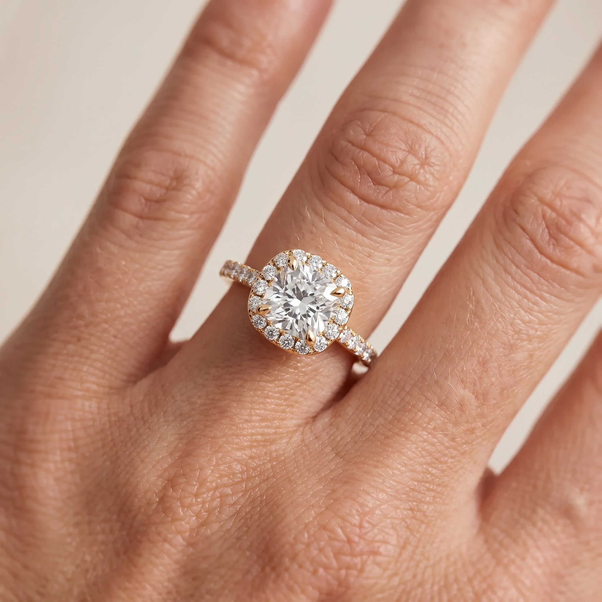 Amara Halo Claw Prong Cushion Diamond Ring in Yellow Gold - lifestyle.jpg