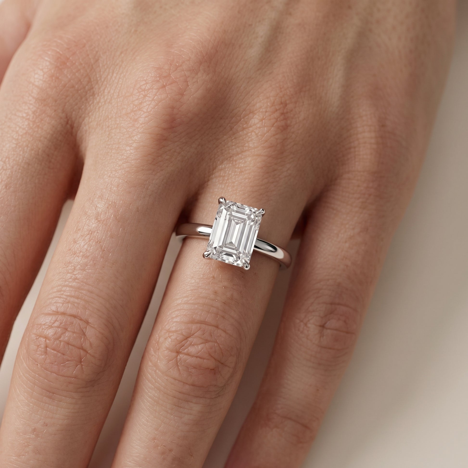 Lyla Petite Solitaire Emerald Diamond Engagement Ring in Silver - lifestyle.jpg