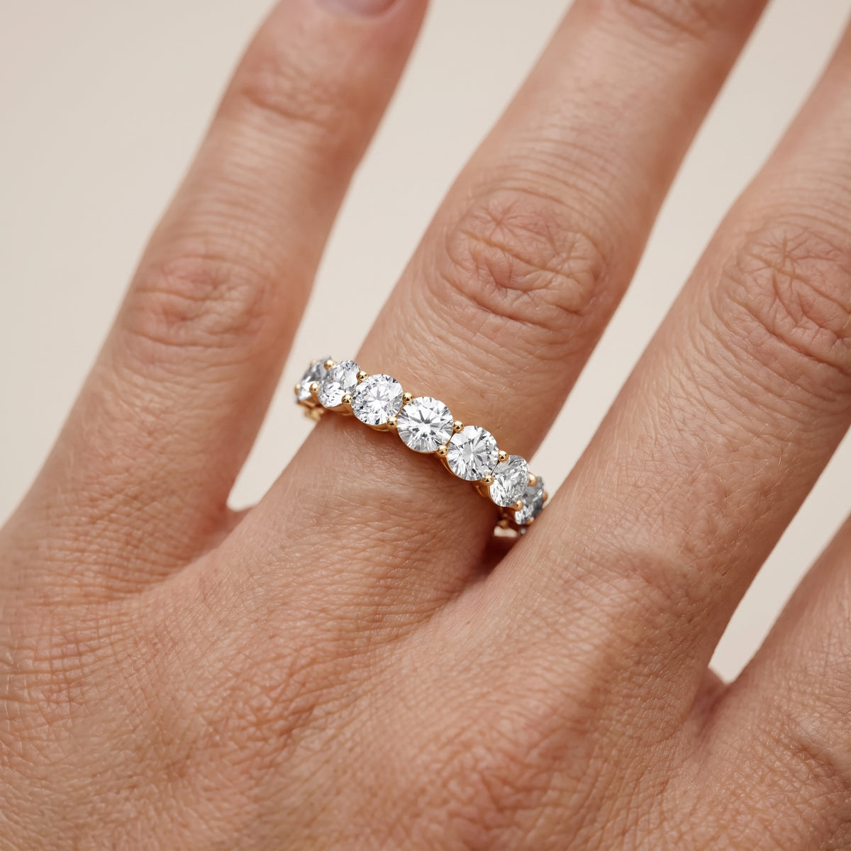 Malia Shared Prong Round & Emerald Diamond Eternity Band in Yellow Gold - lifestyle.jpg