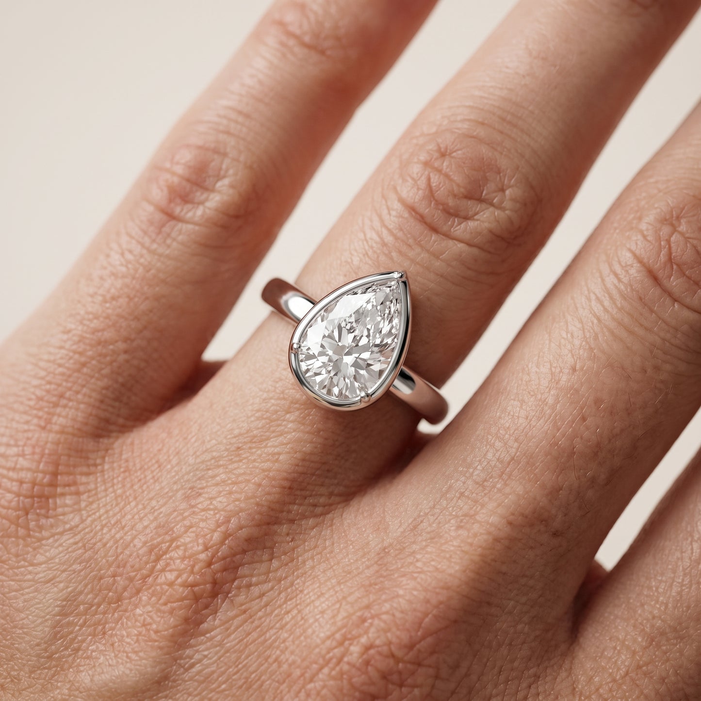 Alina Bezel Solitaire Pear Diamond Ring in White Gold - lifestyle.jpg