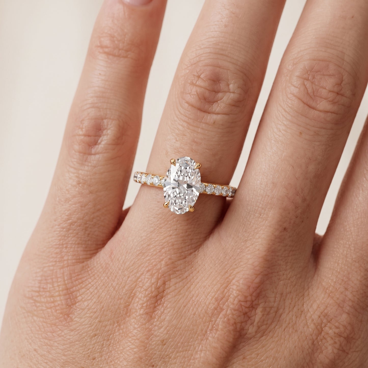 Thea Hidden Halo Pavé Oval Diamond Engagement Ring in Yellow Gold - lifestyle.jpg