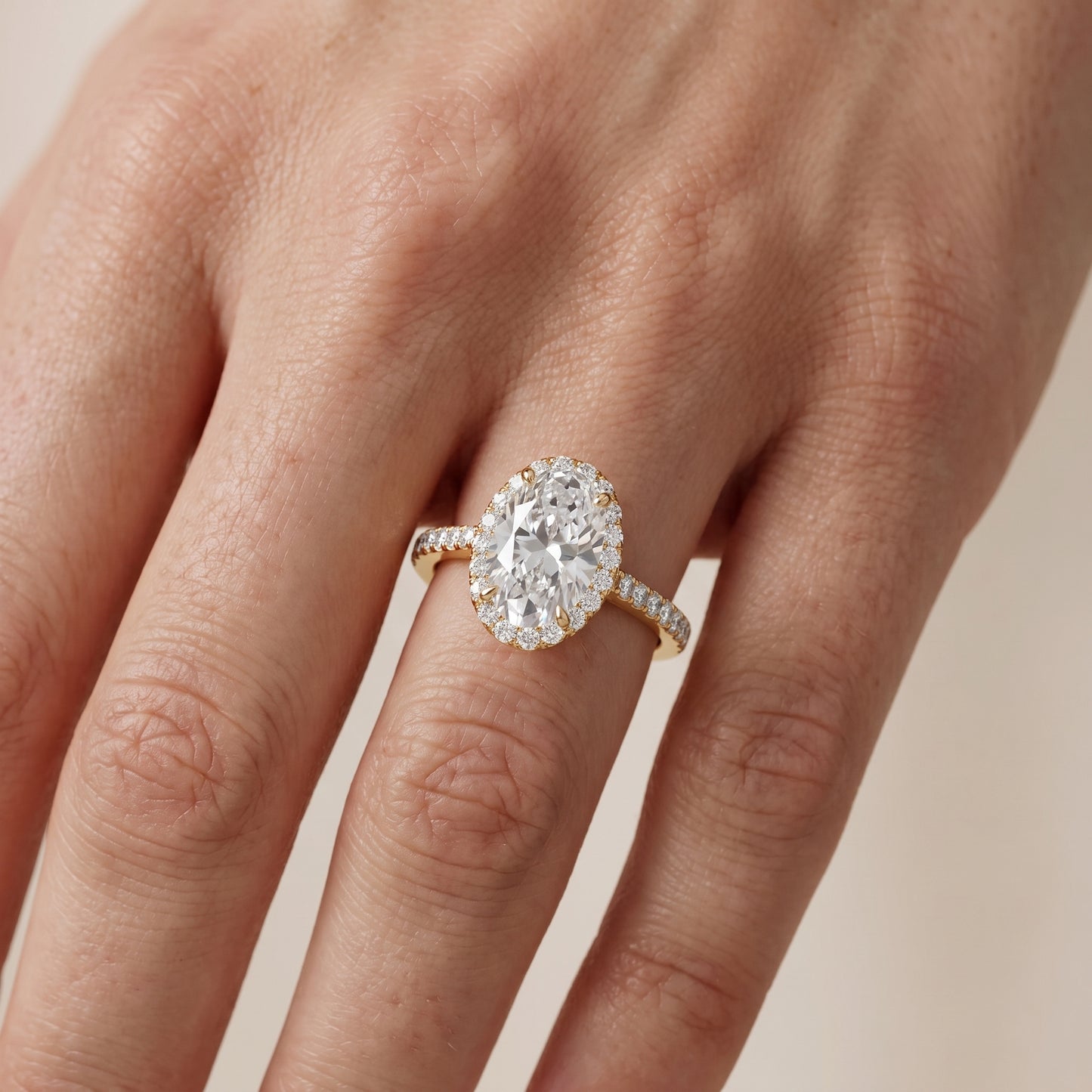 Alma Halo Pavé Oval Diamond Ring in Yellow Gold - lifestyle.jpg