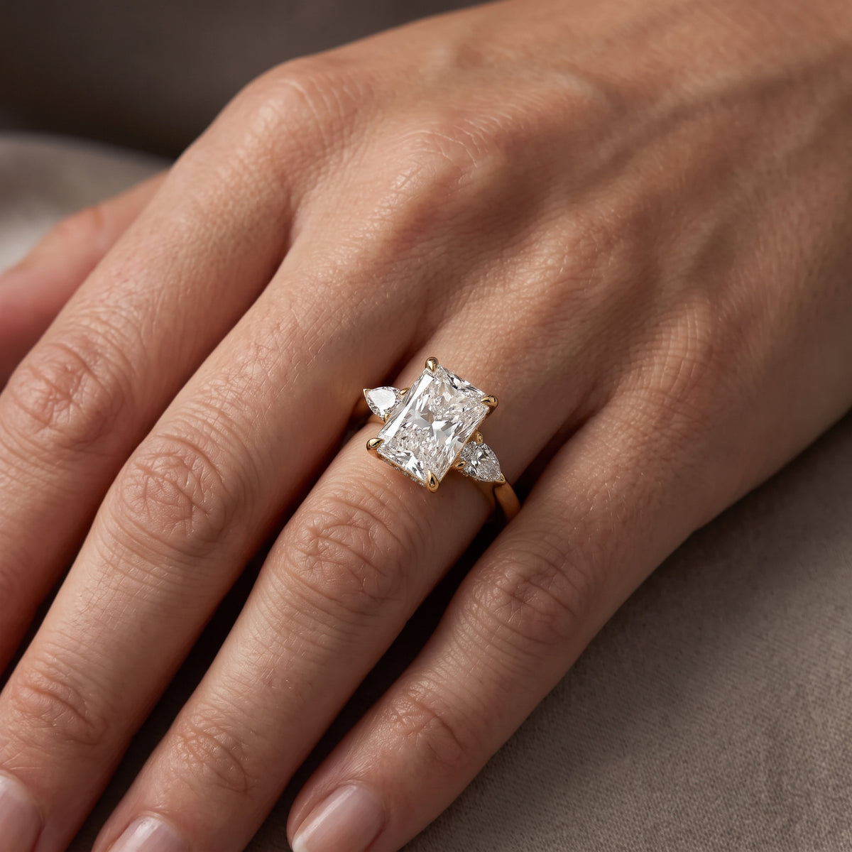 Leila Three-Stone Radiant Diamond Engagement Ring in Yellow Gold - lifestyle.jpg