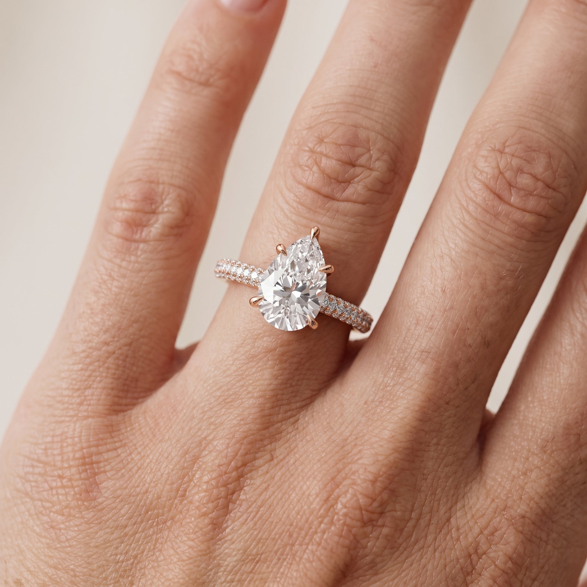 Della Hidden Halo Pavé Pear Diamond Engagement Ring in Rose Gold - lifestyle.jpg