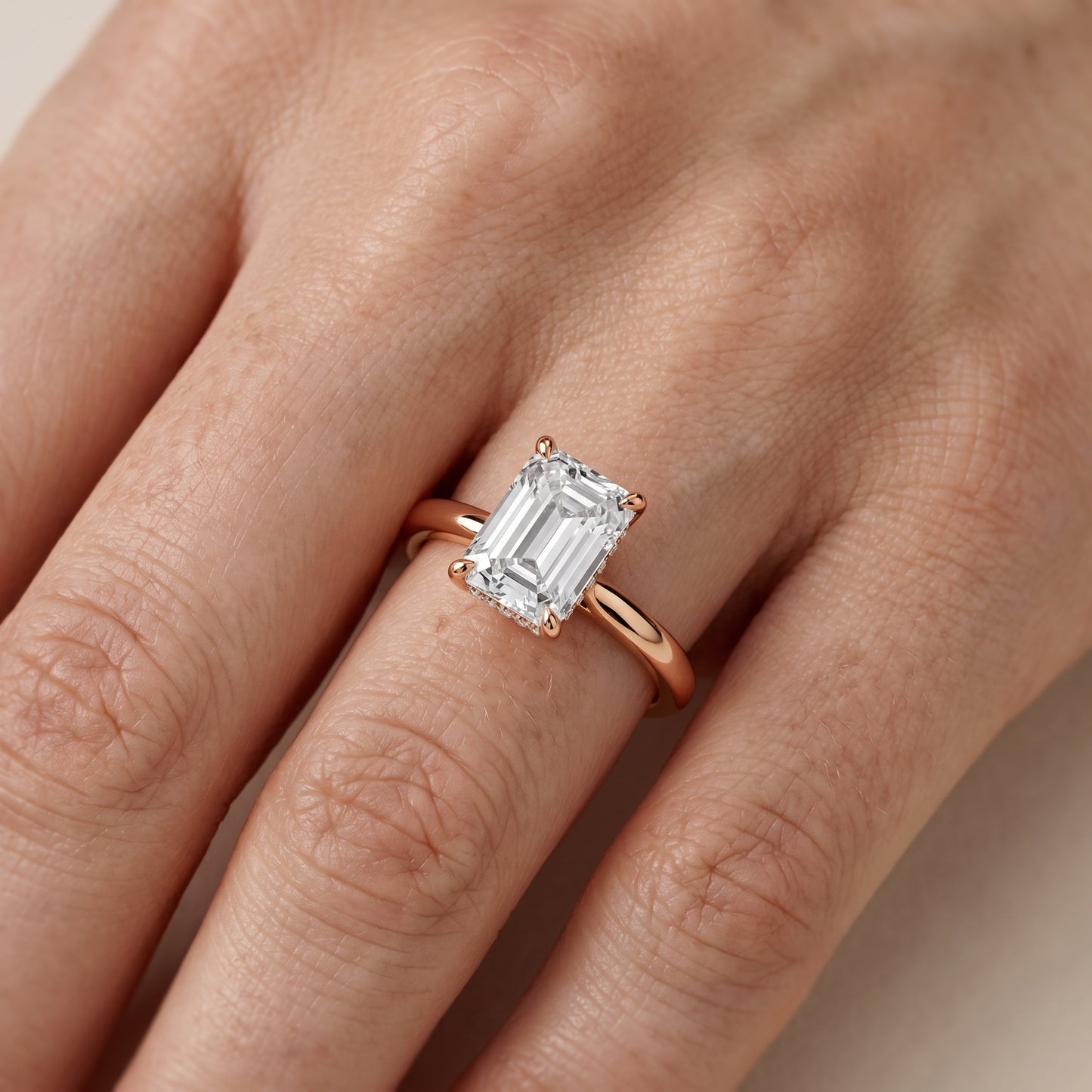 Mena Hidden Halo Emerald Diamond Engagement Ring in Rose Gold - lifestyle.jpg