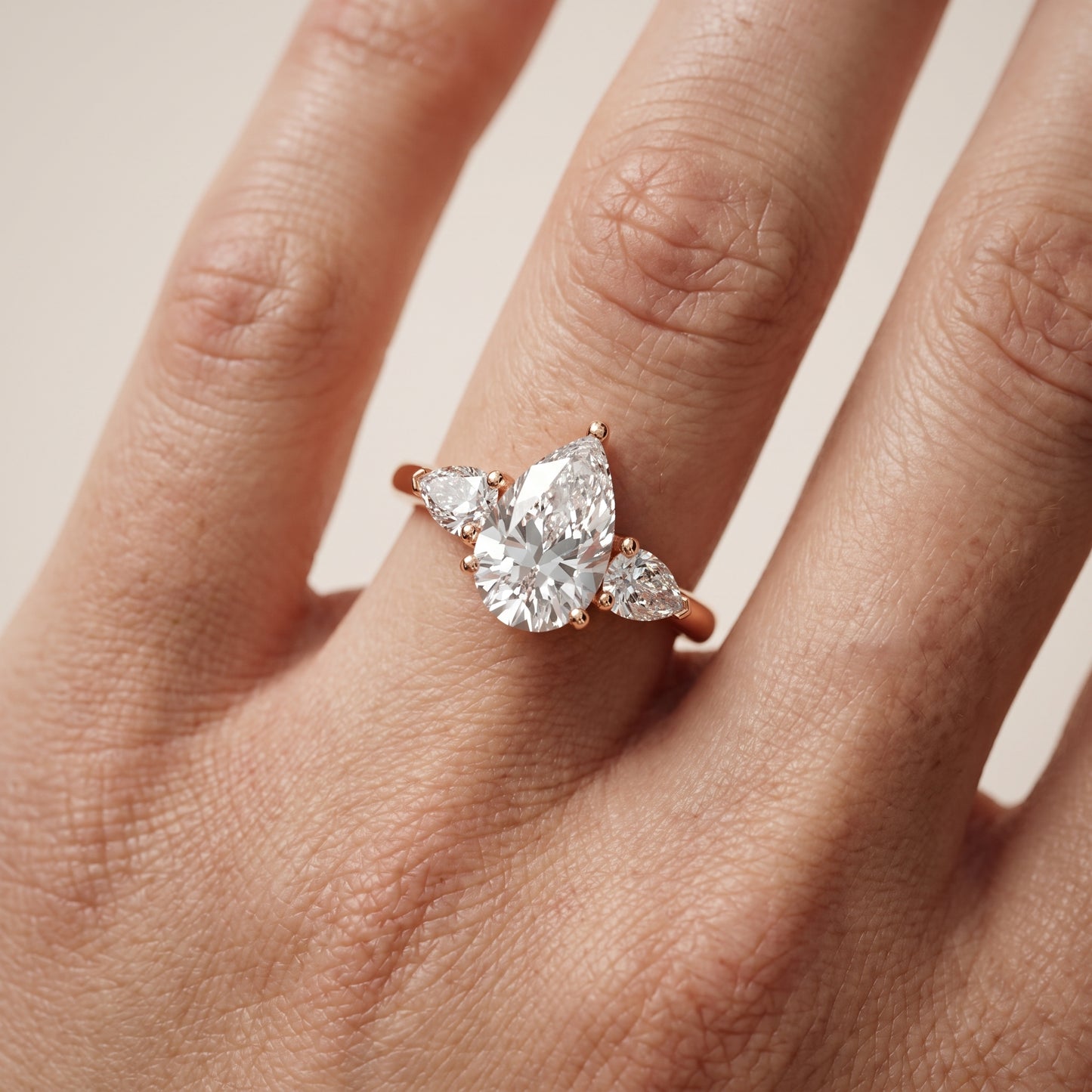 Mirabel Three-Stone Pear Diamond Engagement Ring in Rose Gold - lifestyle.jpg