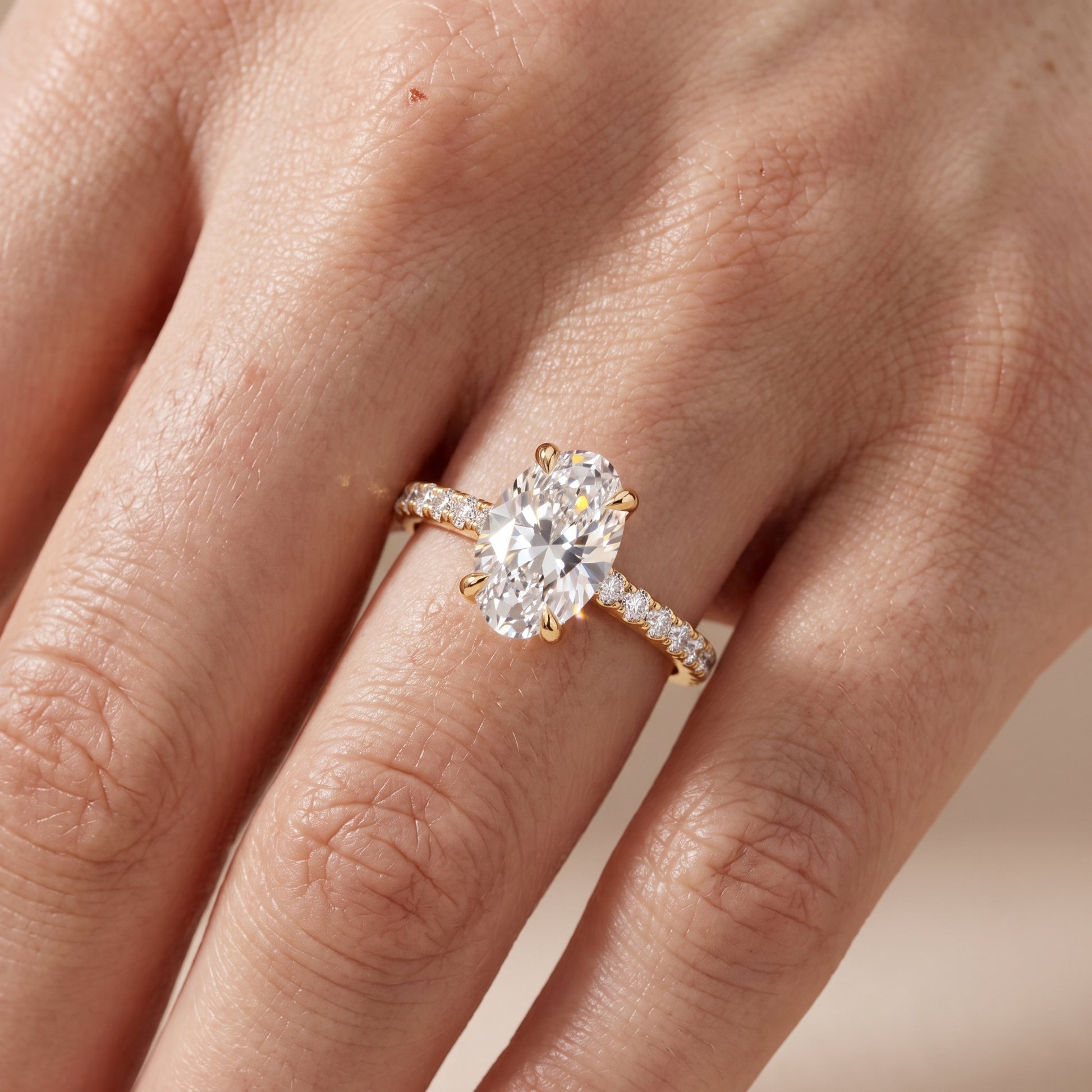Maya Hidden Halo Pavé Oval Diamond Engagement Ring in Yellow Gold - lifestyle.jpg