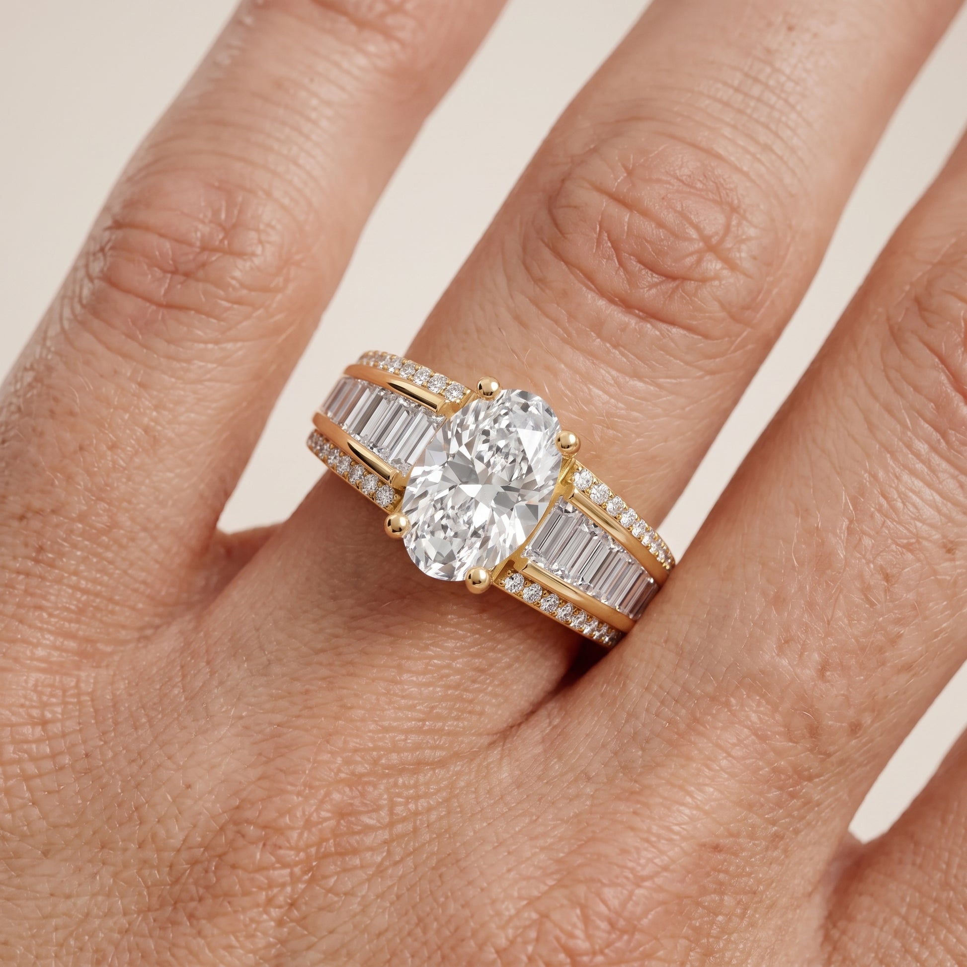 Halle Channel Set Baguette Accent Oval Diamond Engagement Ring in Yellow Gold - lifestyle.jpg