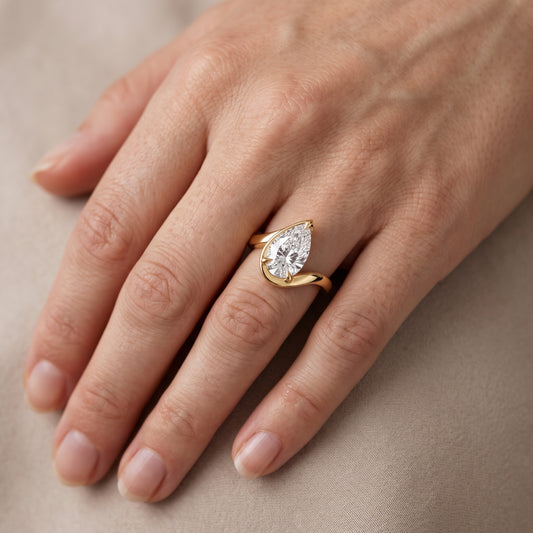 Margaux Bypass Solitaire Pear Diamond Engagement Ring in Yellow Gold - lifestyle.jpg