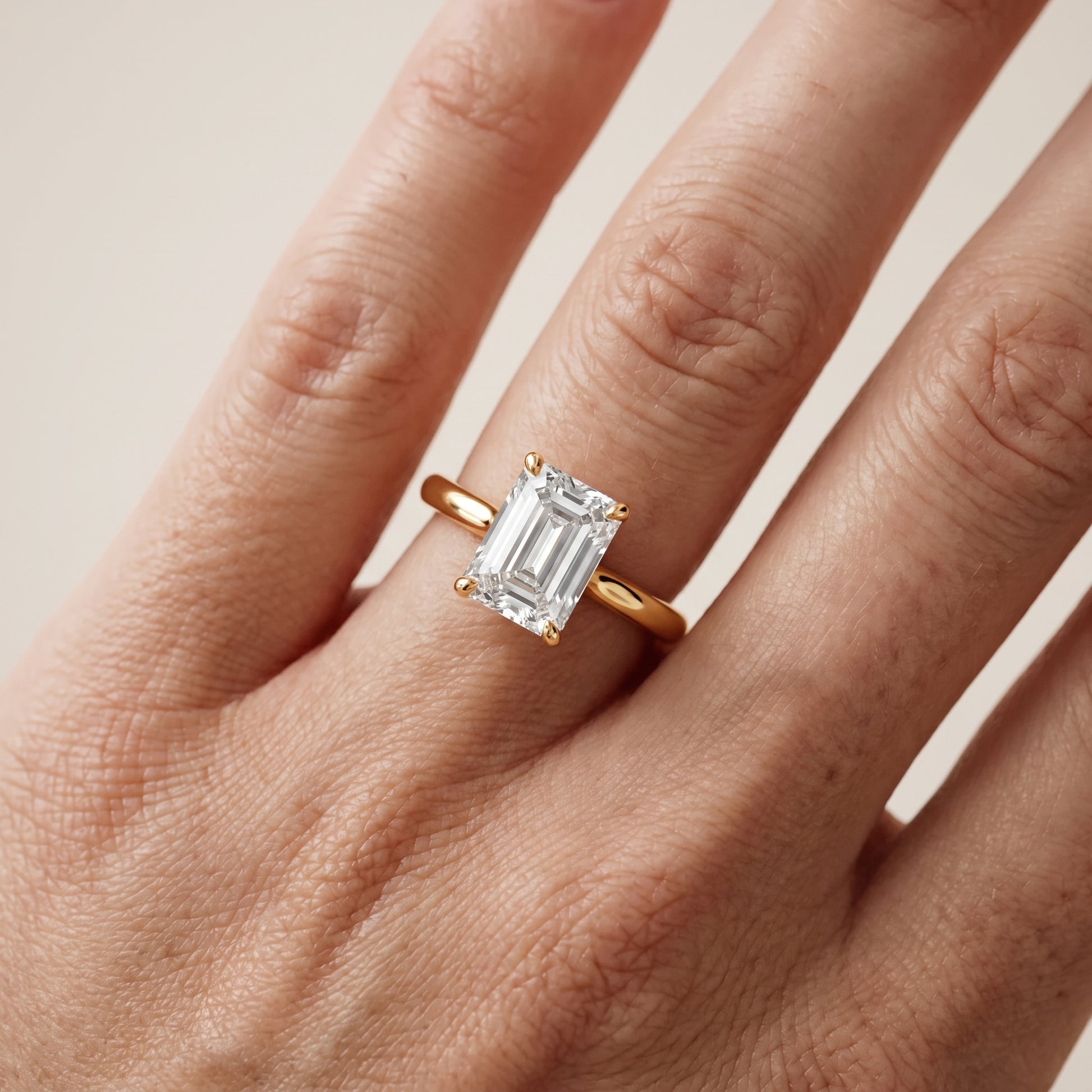 Mena Hidden Halo Emerald Diamond Engagement Ring in Yellow Gold - lifestyle.jpg