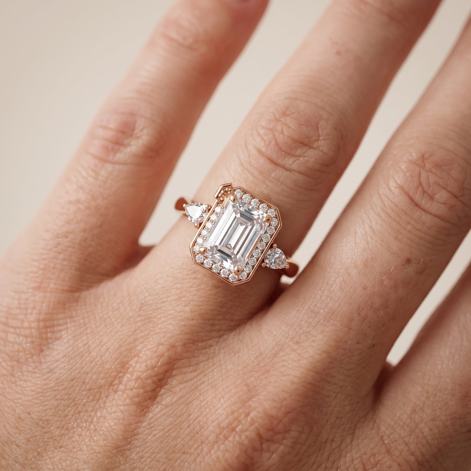 Eliza Halo Sidestone Emerald Diamond Engagement Ring in Rose Gold - lifestyle.jpg