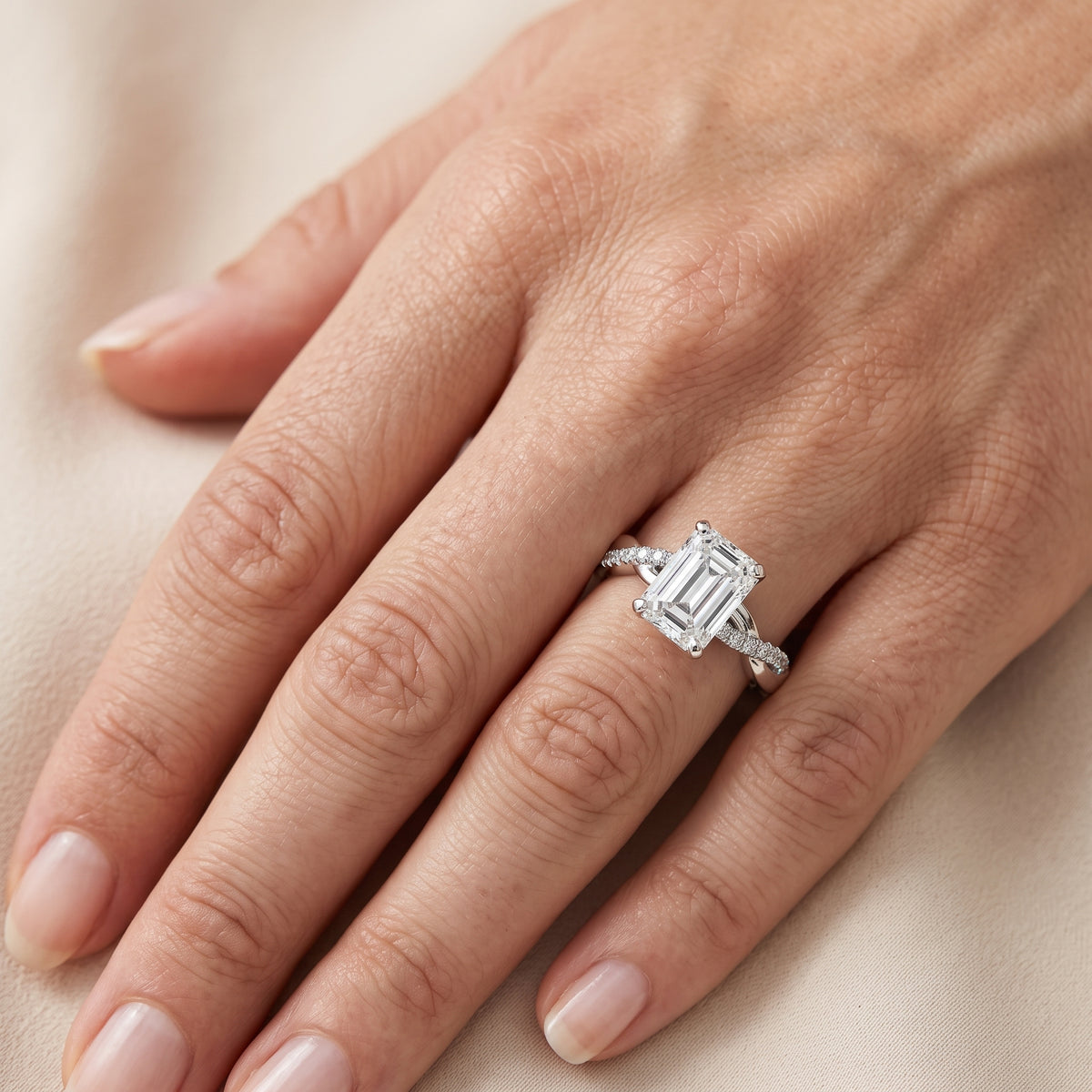 Twisted Side Stone Emerald Diamond Engagement Ring in Silver - lifestyle.jpg