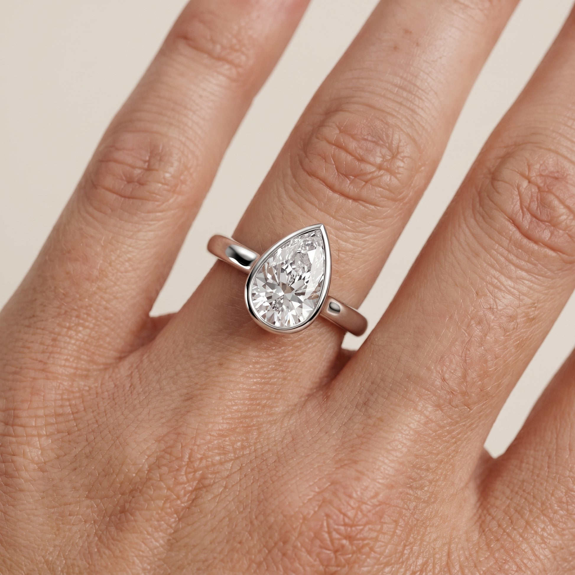 Jolie Bezel Solitaire Pear Diamond Engagement Ring in Platinum - lifestyle.jpg