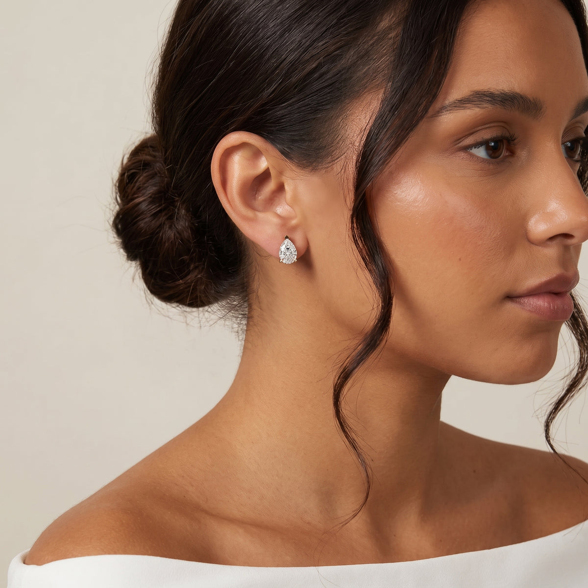 Four Prong Pear Diamond Stud Earrings in Yellow Gold - on model