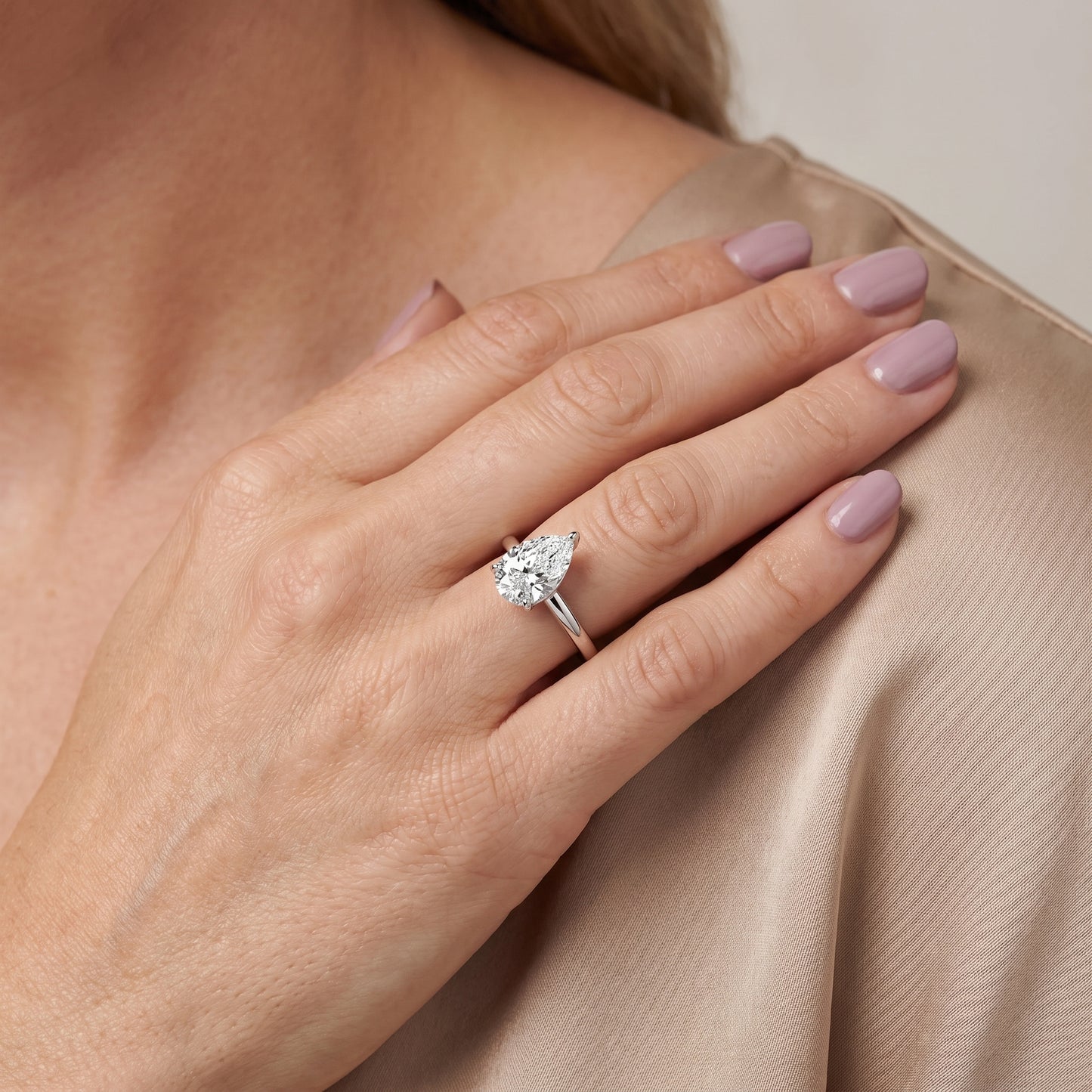 Lyla Petite Solitaire Pear Diamond Engagement Ring in Silver - model.jpg
