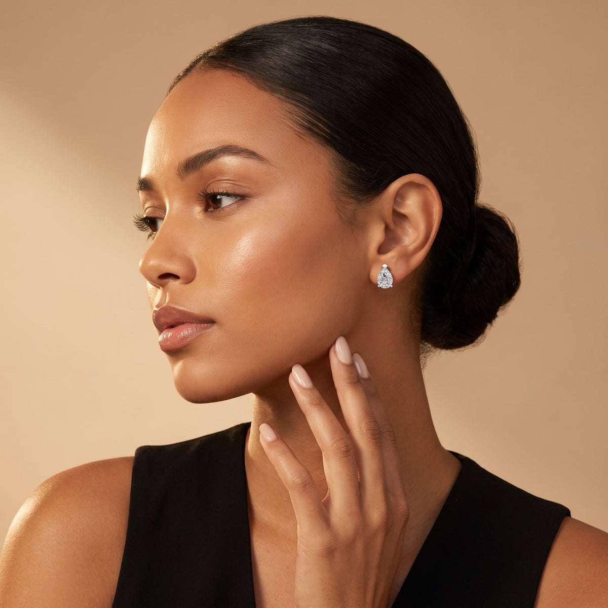 Four Prong Pear Diamond Stud Earrings in Platinum - on model