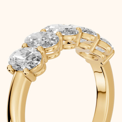 Estela Shared Prong Oval Diamond Wedding Band in Yellow Gold - slant-view