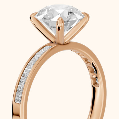 Maren Sidestone Channel Set Round Diamond Engagement Ring in Rose Gold - slant-view.webp