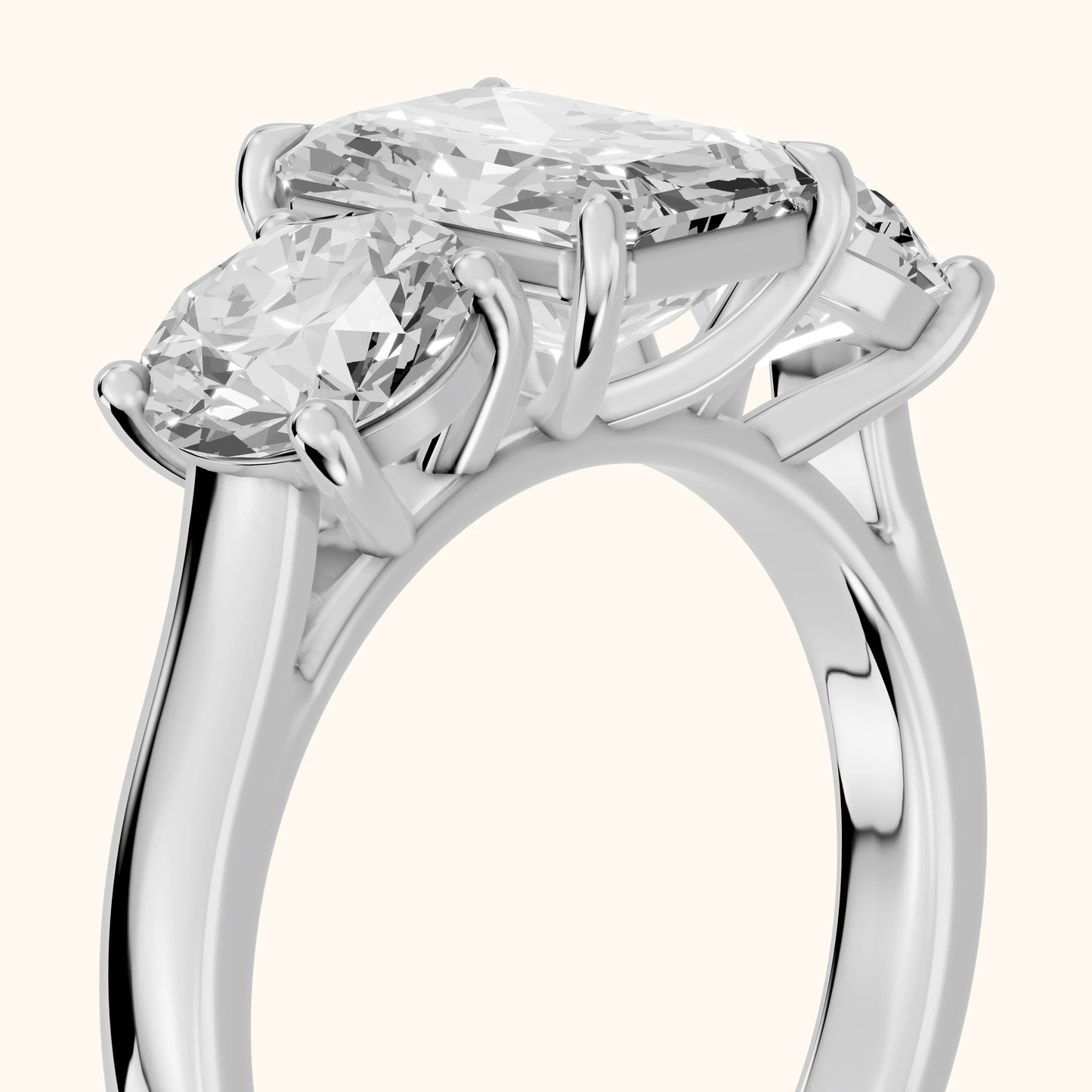 Esme Three-Stone Tapered Emerald Diamond Ring in Platinum - slant-view.webp