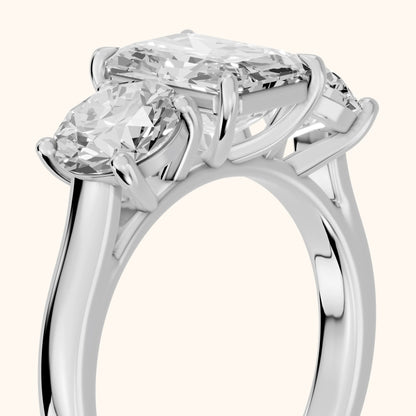 Esme Three-Stone Tapered Emerald Diamond Ring in Platinum - slant-view.webp