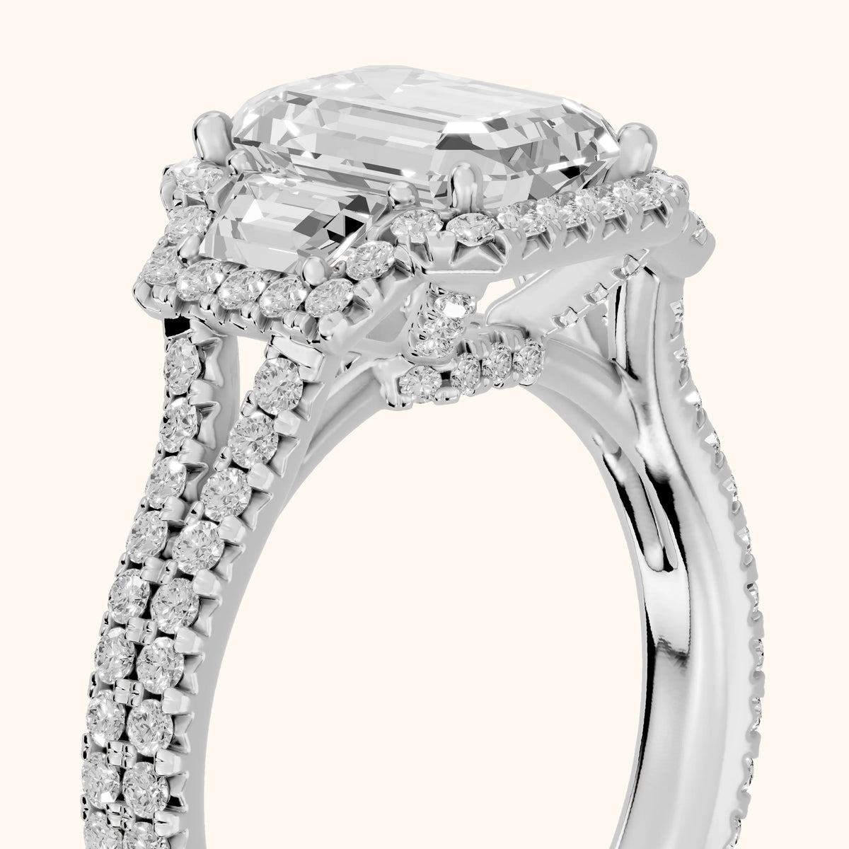 Ronan Three-Stone Halo Emerald Diamond Engagement Ring in Platinum - slant-view.webp