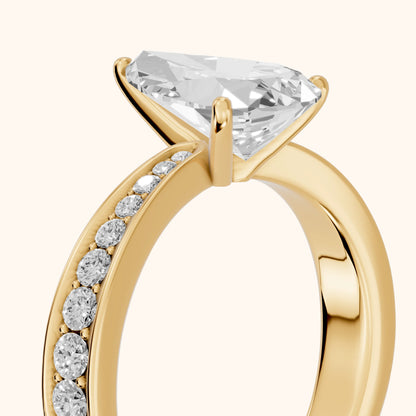 Rhea Sidestone Pavé Pear Diamond Engagement Ring in Yellow Gold - slant-view.webp