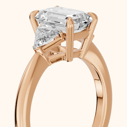 Clemency Three-Stone Cathedral Emerald Diamond Engagement Ring in Rose Gold - slant-view.webp