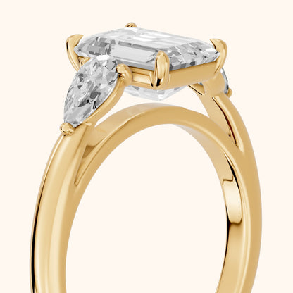 Phoebe Three-Stone Emerald Diamond Ring in Yellow Gold - slant-view.webp