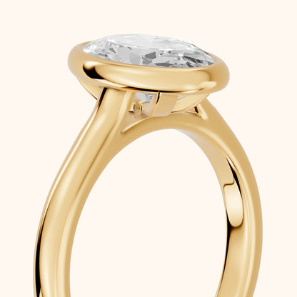 Jolie Bezel Solitaire Oval Diamond Engagement Ring in Yellow Gold - slant-view.webp